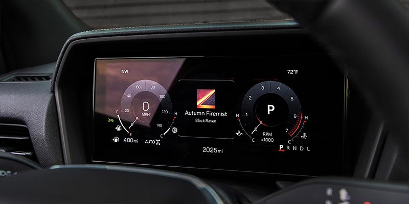 Digital car dashboard display showing speedometer, tachometer, and vehicle info screen.